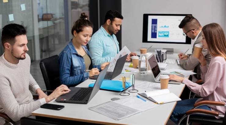 People sit at a desk and work
